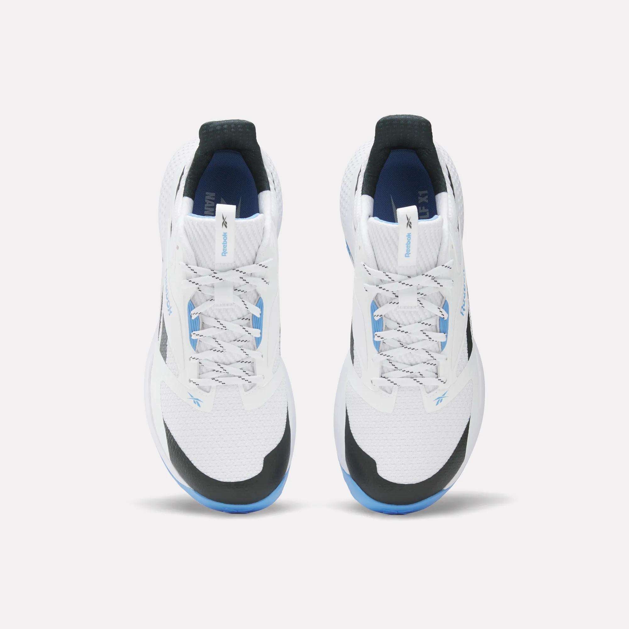The Reebok Nano Golf Shoes are white athletic sneakers with black and blue accents, seen from above on a white background. They feature white laces, a FlexWeave mesh upper for modern style, and enhanced performance foam for comfort.