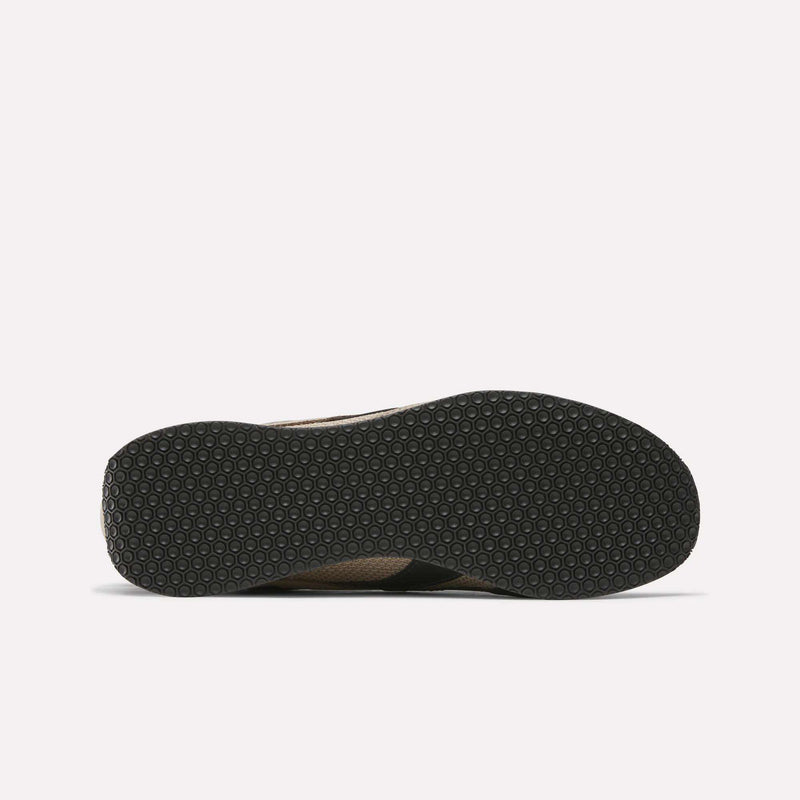 The image displays the bottom of a black sole from Reebok R400 Shoes, featuring a textured pattern of small, evenly spaced hexagons, set against a white background.