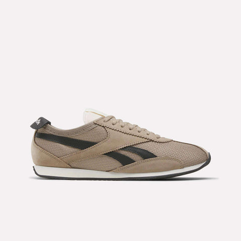The Reebok R400 Shoes are beige sneakers with a textured upper, suede accents, black side stripes, white sole, and beige laces, displayed in side profile on a plain white background.