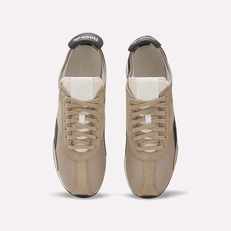 A pair of beige Reebok R400 Shoes shown from above, featuring white tongues, beige laces, and black Reebok branding on the heel tabs—stylish vintage sneakers on a plain light background.