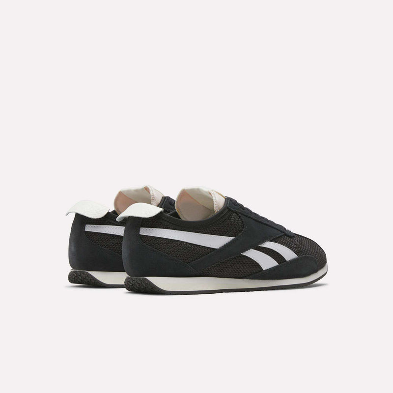 The Reebok R400 Shoes, shown in black with white side stripes and heel tabs, are angled from the back on a light background, highlighting classic details inspired by vintage sneakers.