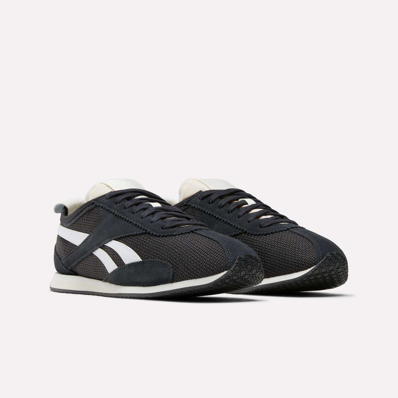 A pair of Reebok R400 Shoes in black with white soles, white side stripes, and black laces exemplifying retro running style, displayed on a plain white background.