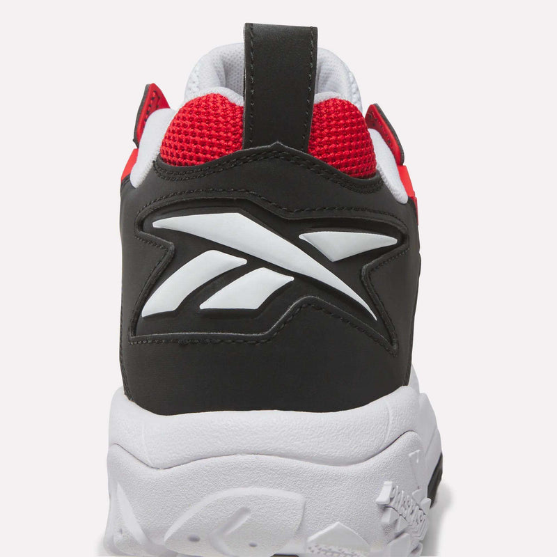 Get a close-up look at the Reebok Brutus Low Shoes, featuring a black and white design with bold red mesh accents, the iconic Reebok logo on the heel, and a thick white sole for true street-ready style.