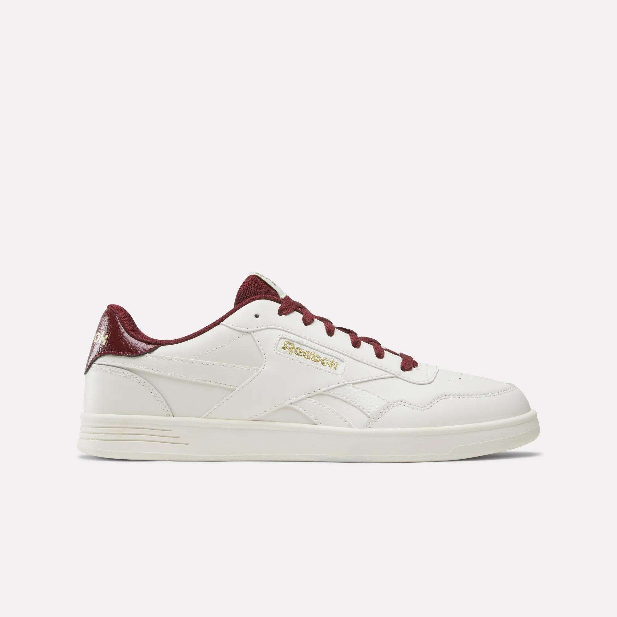 The Reebok Court Advance Shoes feature a white design with maroon laces, a maroon heel accent, and gold Reebok branding on the side, shown against a plain light background. Inspired by classic courts, these sneakers offer everyday comfort.