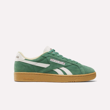 The Reebok Club C Grounds UK Shoes feature a green suede upper with white accents, a white logo, and a tan gum sole, displayed in side profile against a plain white background.