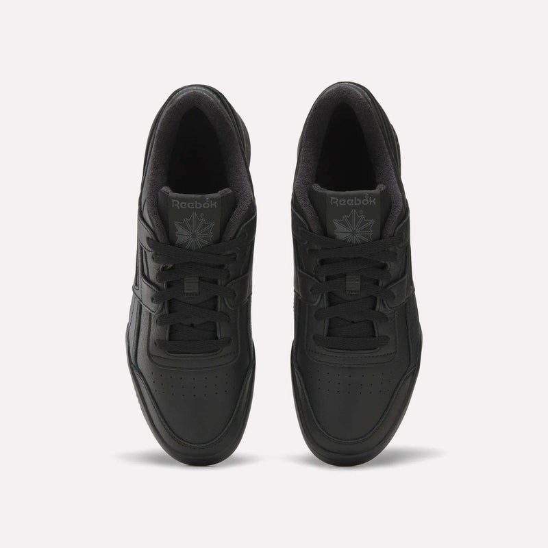 A top view of Reebok Workout Plus Shoes in black reveals laces, perforated toe boxes, and the Reebok logo on the tongues, showcasing classic '80s fitness style against a plain white background.