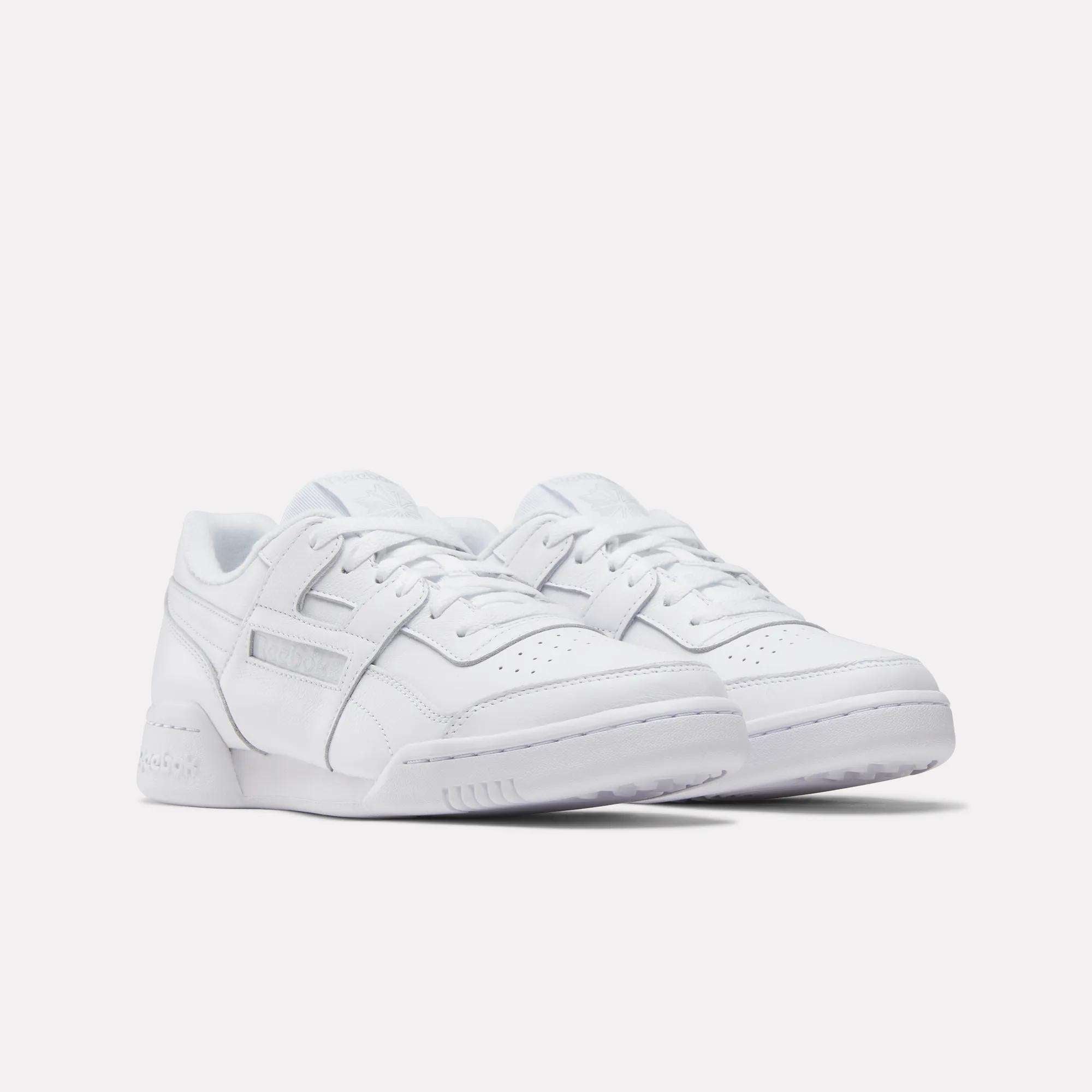 The Reebok Workout Plus Shoes are white low-top sneakers with laces, perforated toe boxes, and subtle stitching details, showcasing the iconic '80s fitness style in classic Reebok design against a plain white background.