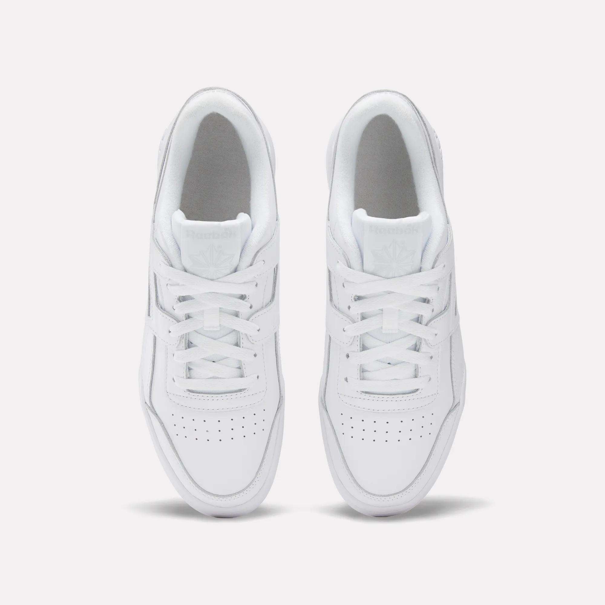 Top view of Reebok Workout Plus Shoes, featuring clean white leather, neatly tied laces, perforated toes, and visible branding on the tongue—a classic '80s style against a plain light background.