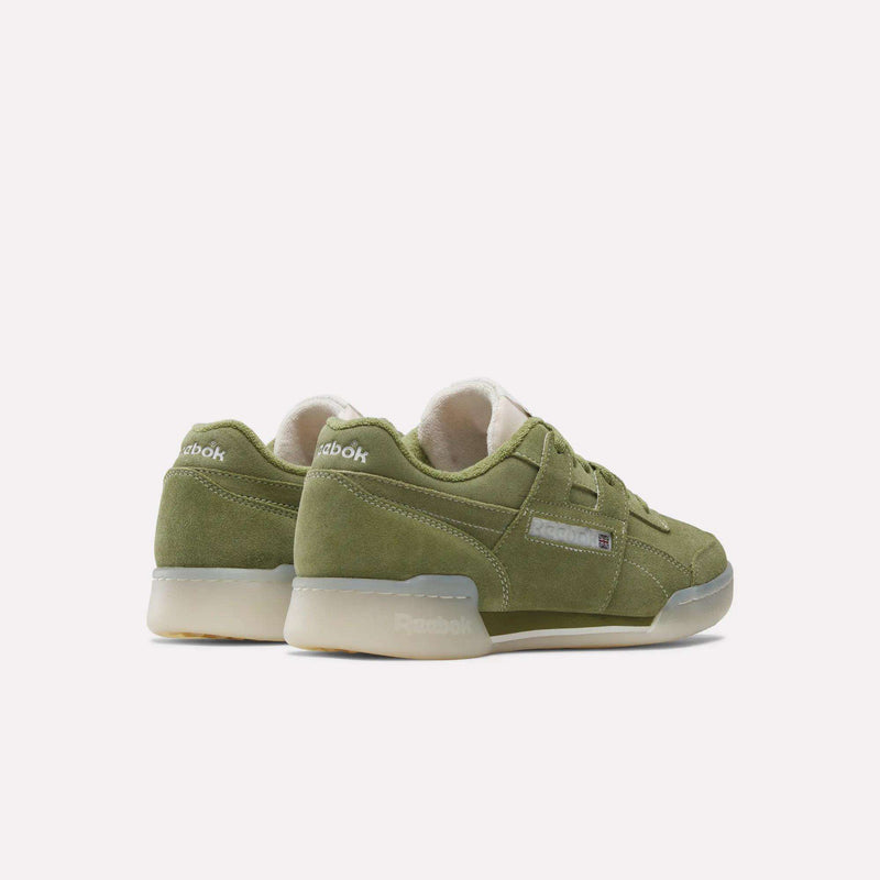 A pair of Reebok Workout Plus Shoes in olive green suede with beige midsoles and gum outsoles, shown angled to highlight their classic '80s fitness style from the side and back views.