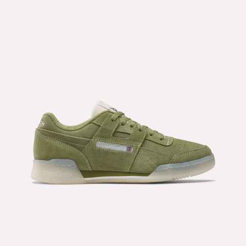 The Reebok Workout Plus Shoes feature green suede uppers, a white sole, and a classic low-top design—shown side profile on a white background—capturing the iconic ’80s fitness style.