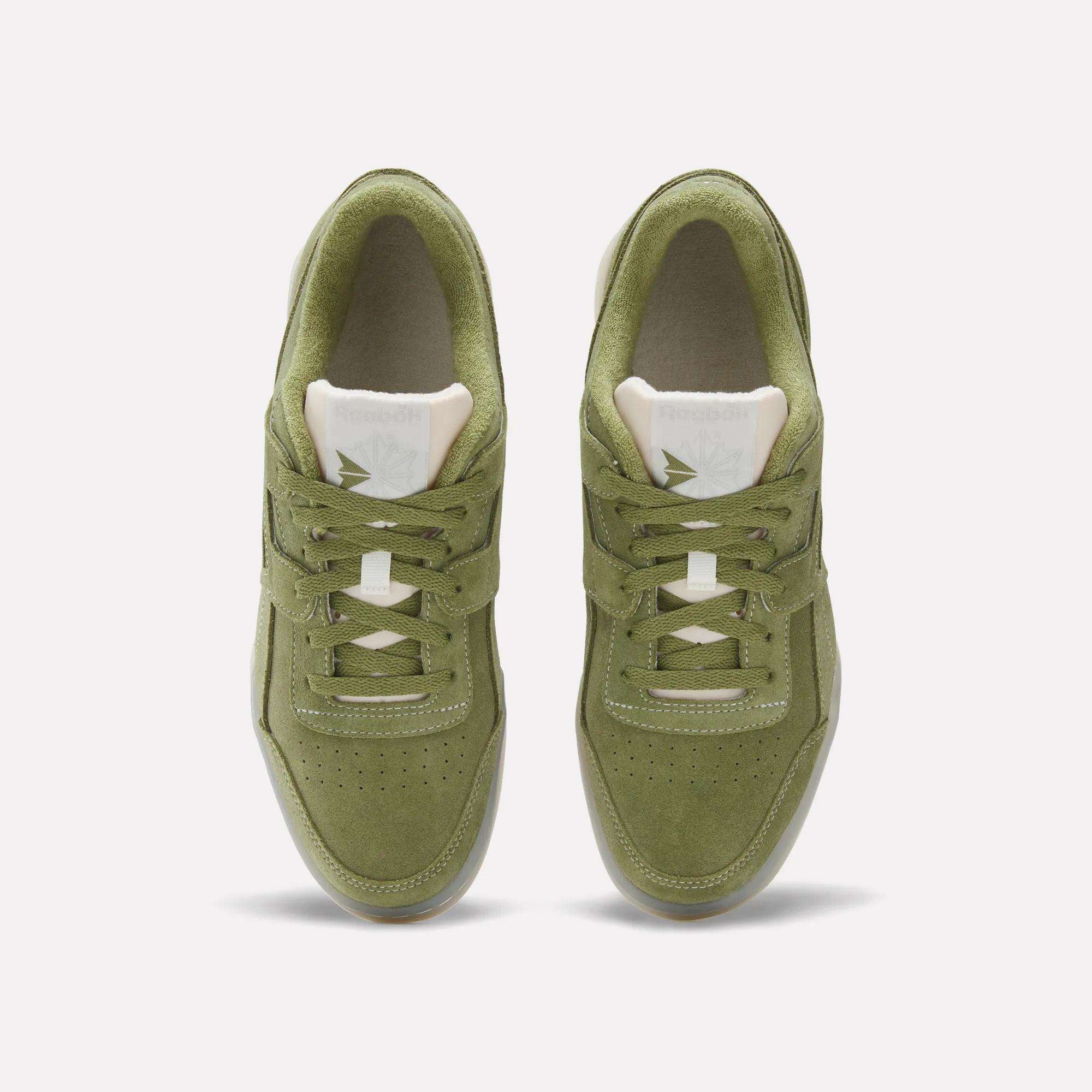 Top view of Reebok Workout Plus Shoes in green suede, featuring white tongues and beige interiors, shown side by side on a plain white background for a classic '80s fitness vibe.