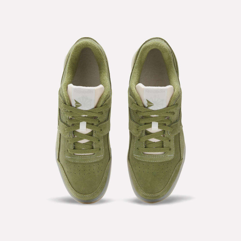 Top view of Reebok Workout Plus Shoes in green suede, featuring white tongues and beige interiors, shown side by side on a plain white background for a classic '80s fitness vibe.