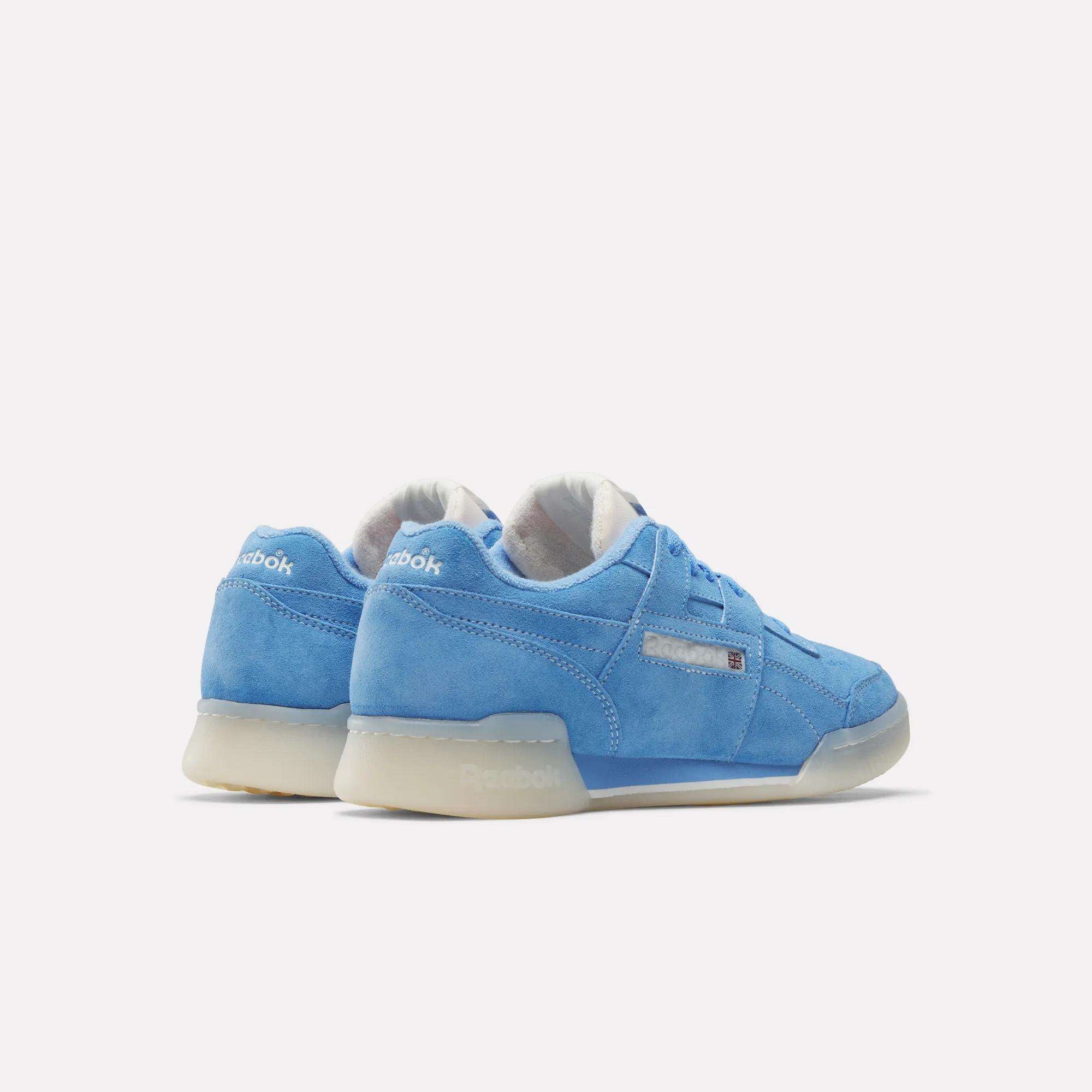 A pair of Reebok Workout Plus Shoes in blue suede with white accents and translucent rubber soles, set on a plain white background, evoke the classic '80s fitness style.