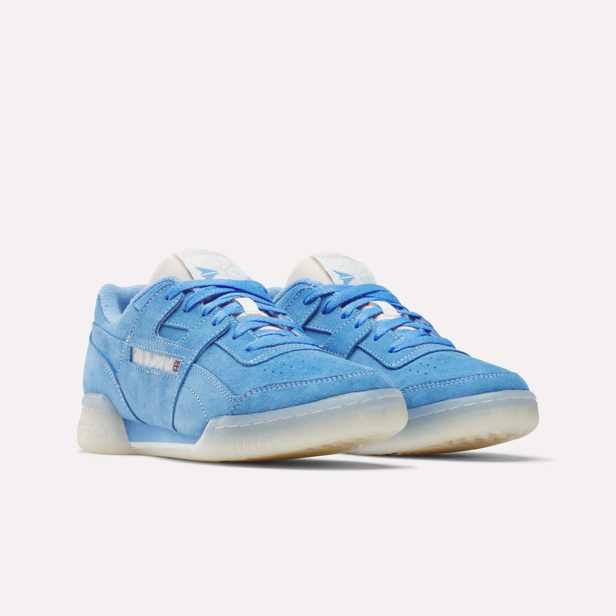 A pair of Reebok Workout Plus Shoes in light blue suede with white soles and laces, inspired by '80s fitness style and classic workout design, featuring subtle branding and a translucent rubber outsole on a plain white background.