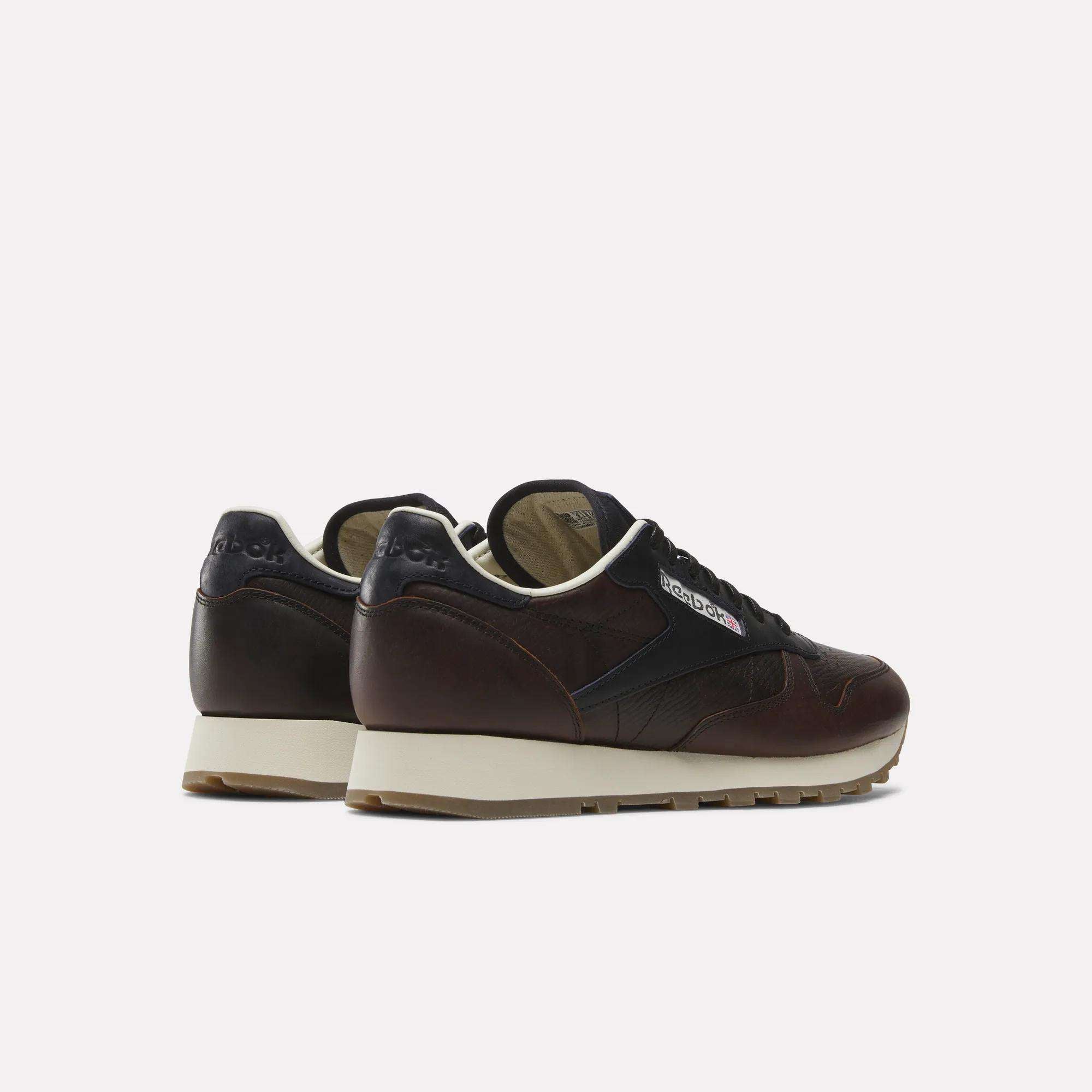 The Reebok x C.F. Stead Classic Leather Shoes, featuring dark brown and black luxe leather with beige soles, are displayed on a white background and shown from the back and side.