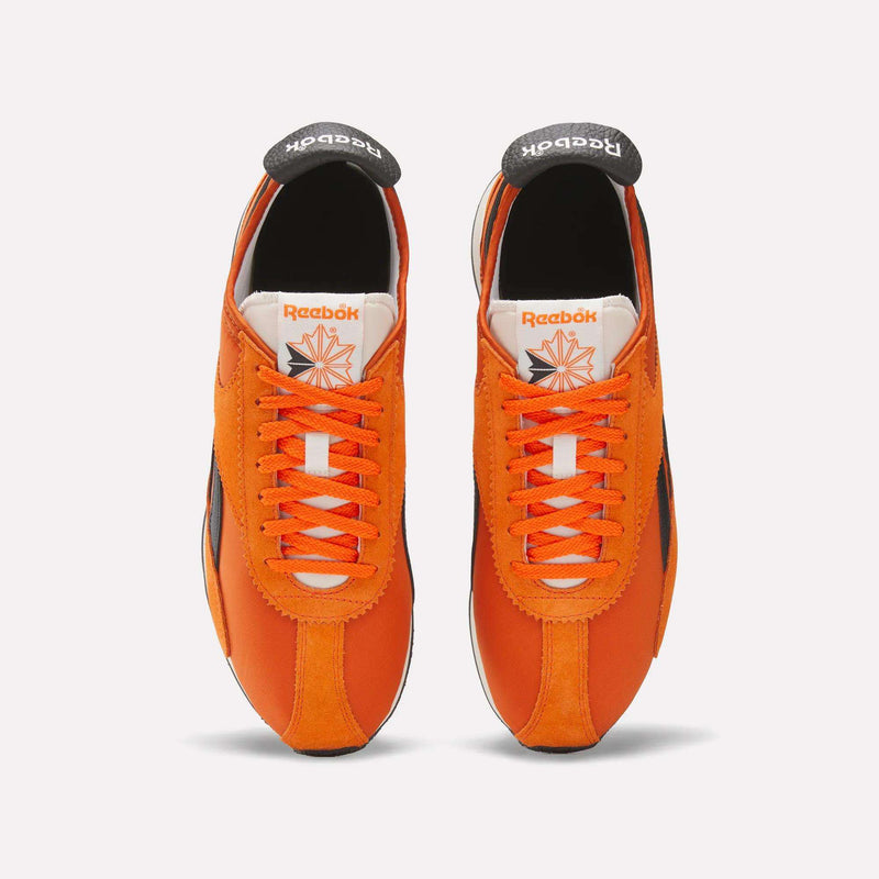 A pair of Reebok R400 Shoes in orange and white.