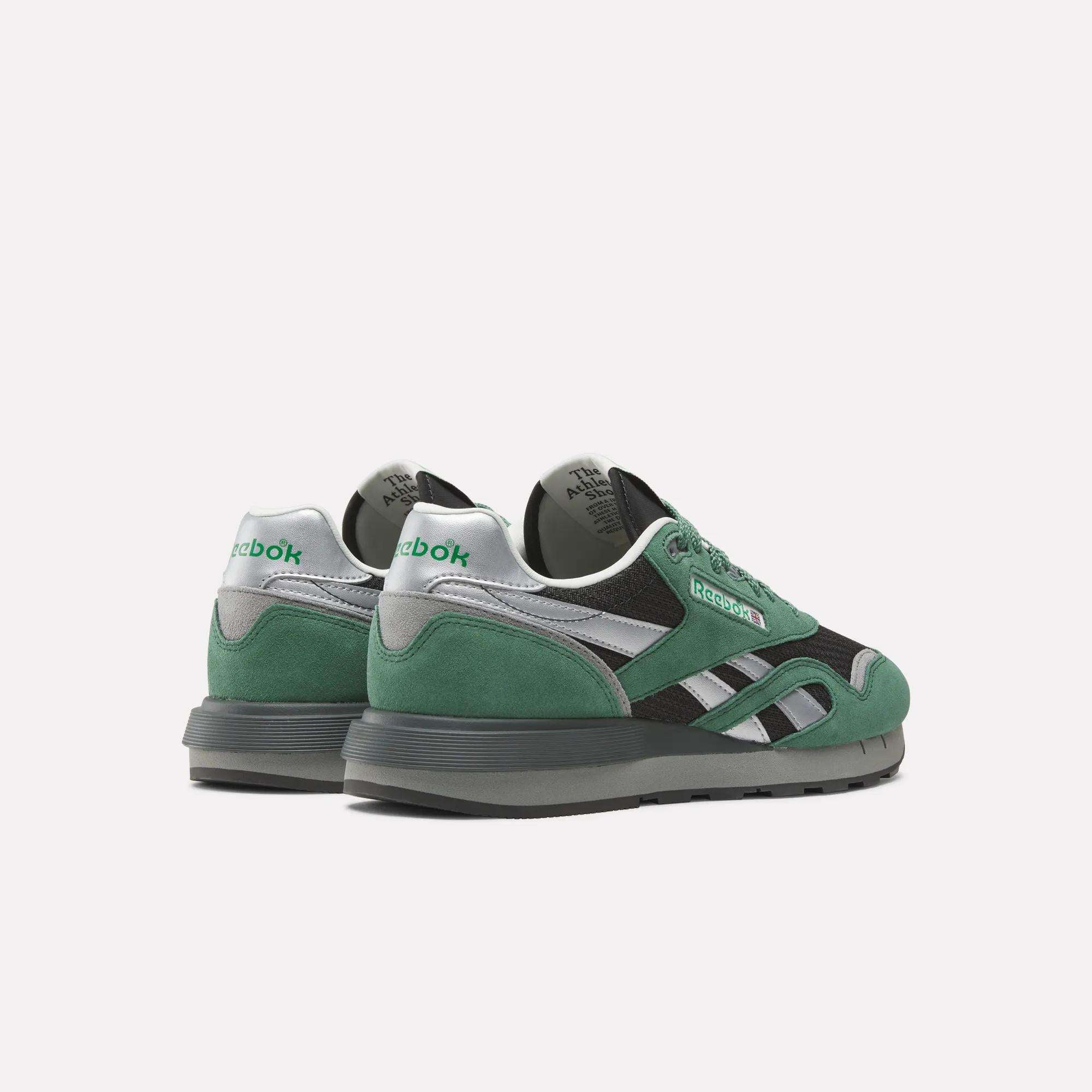 A pair of Reebok Classic Nylon 89 Shoes in green suede with black mesh and silver accents, featuring Reebok branding, shown from the back and side angles on a white background.