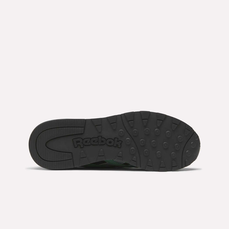 The image displays the black rubber outsole of Reebok’s Classic Nylon 89 Shoes, seen from below, with round grip patterns and "Reebok" embossed in the center, highlighting the shoe's vintage running heritage.