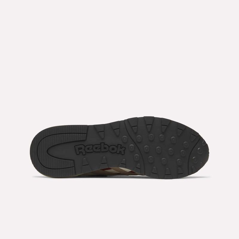 The image displays the black rubber outsole of a Reebok Classic Nylon 89 Shoe, viewed from below. It features circular grips, embossed Reebok branding near the heel, and suggests a cushioned midsole typical of classic running shoes.