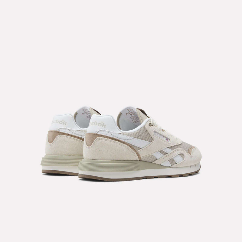 A pair of Reebok Classic Nylon 89 Shoes in beige and white, with suede and mesh panels, cushioned midsole, Reebok logo, and retro design, shown from the back and side on a white background.