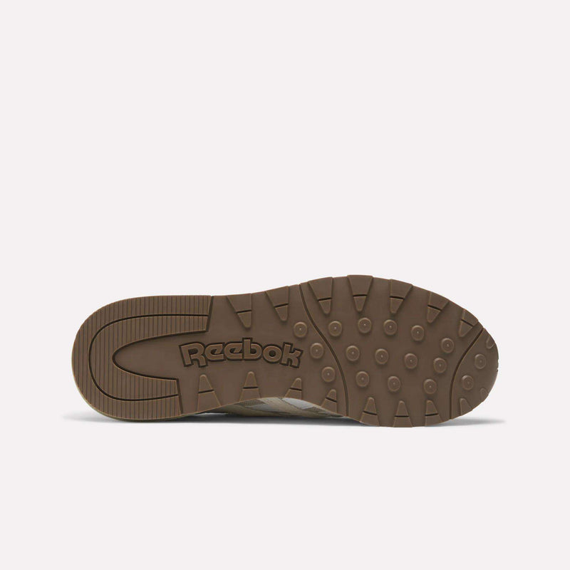 The image shows the bottom view of Reebok Classic Nylon 89 Shoes with a brown rubber sole featuring circular treads and the Reebok logo embossed in the center. The plain white background highlights this vintage design.