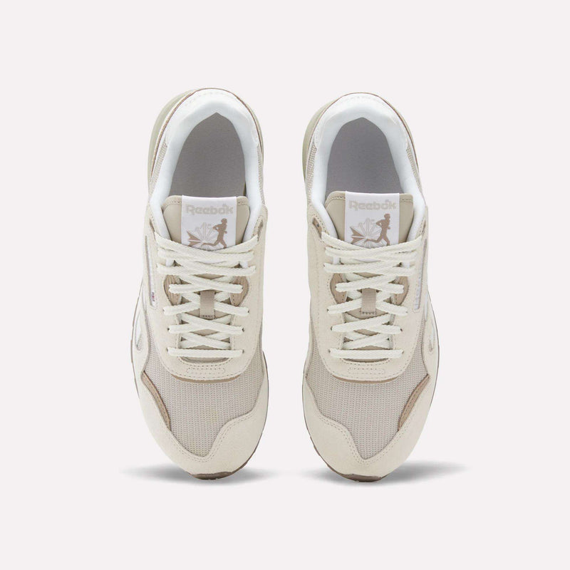 A pair of Reebok Classic Nylon 89 Shoes in beige and white, viewed from above, display mesh and suede details, laces, a cushioned midsole, and the Reebok logo on each tongue.