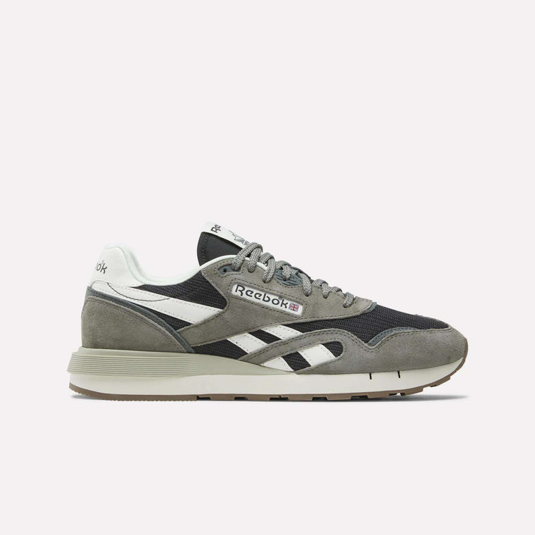 The Reebok Classic Nylon 89 Shoes are displayed in side profile, featuring gray, black, and white suede and mesh panels with white logo stripes and a beige rubber sole, set against a plain light background.