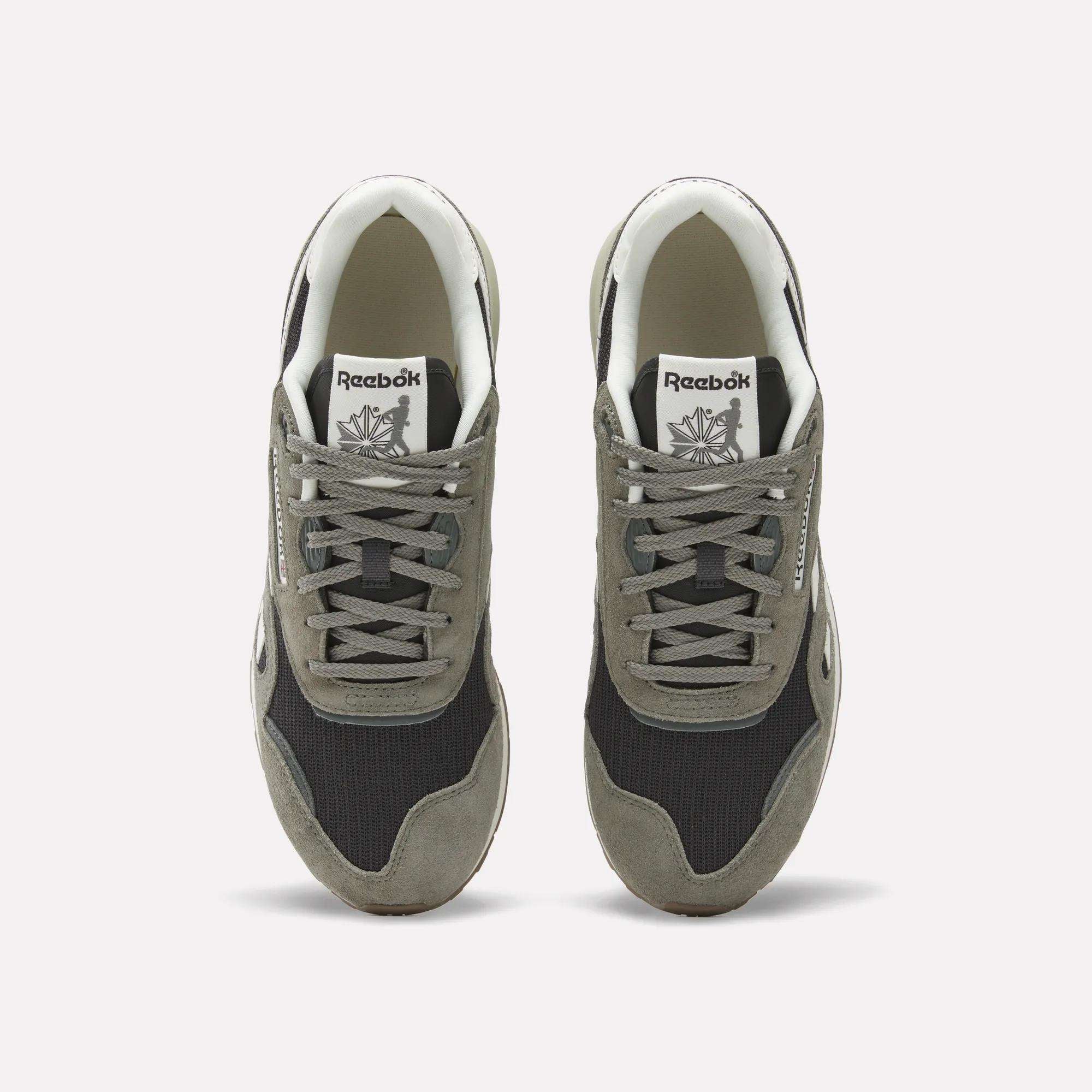 A pair of Reebok Classic Nylon 89 Shoes seen from above, with gray suede overlays, black mesh panels, white midsoles and interiors. Each heritage sneaker displays the Reebok logo on the tongue.