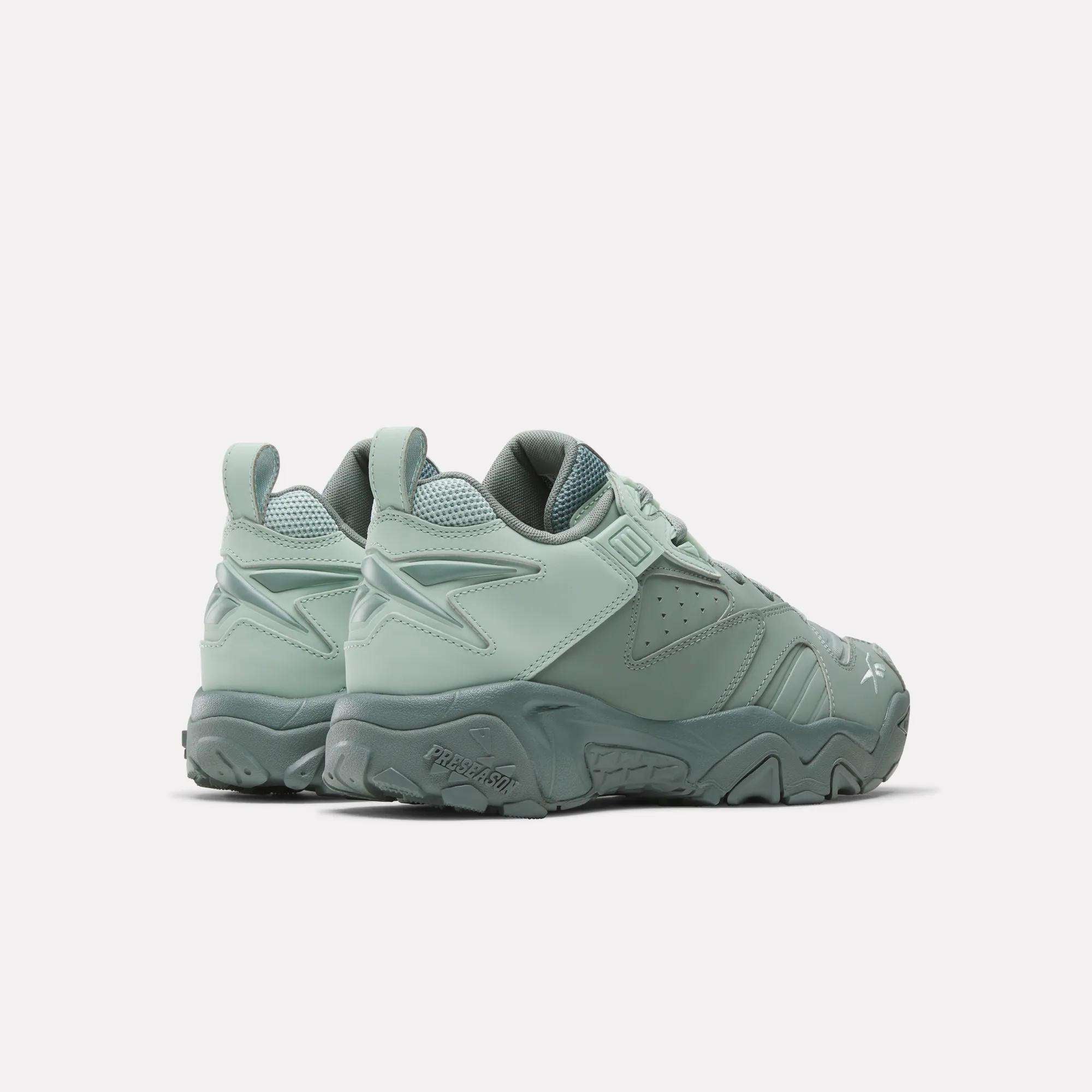 Reebok Brutus Low Shoes in mint green, featuring chunky soles, EVA midsoles, textured detailing, and pull tabs on the heels. Shown from the back and side against a plain white background.
