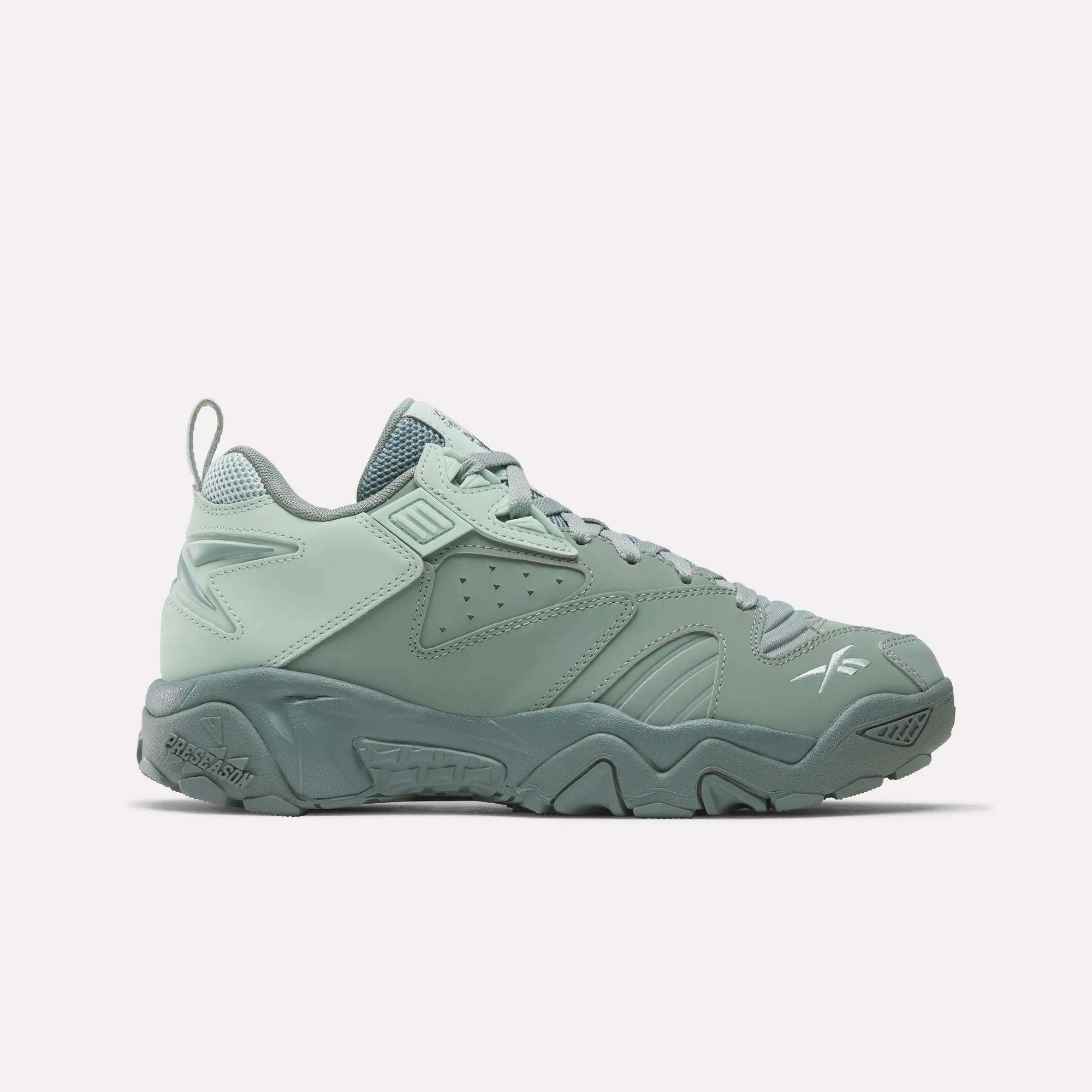 The Reebok Brutus Low Shoes feature a mint green color, chunky sole, perforated details, and textured accents—stylishly displayed in a side profile on a white background for a fresh streetwear look.