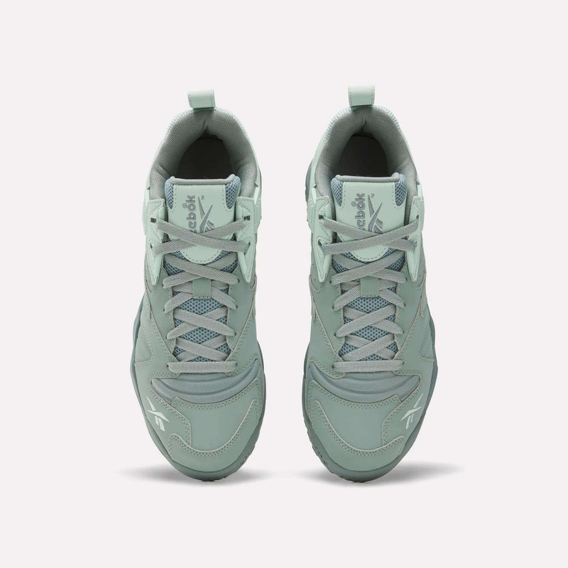 Top view of Reebok Brutus Low Shoes in light green with laces, mesh detailing, and Reebok logos on the tongue and toe. Features an EVA midsole for comfort, shown on a plain white background.