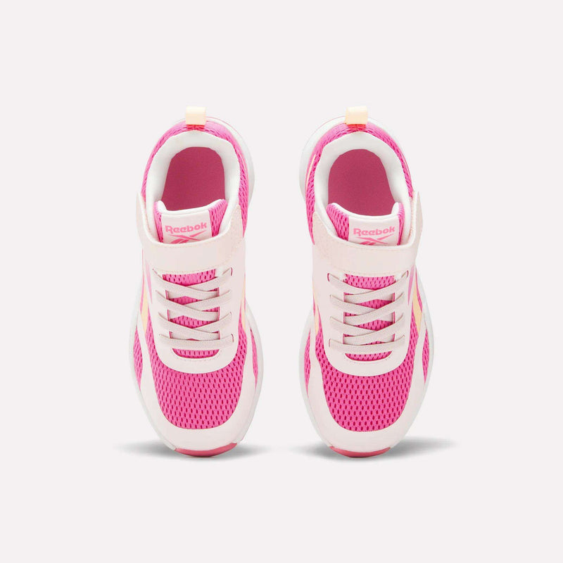 A pair of Reebok Energen Running Shoes for little kids in pink and white, viewed from above, showcasing breathable mesh uppers, laces, and a Velcro strap on each shoe, set against a light background.