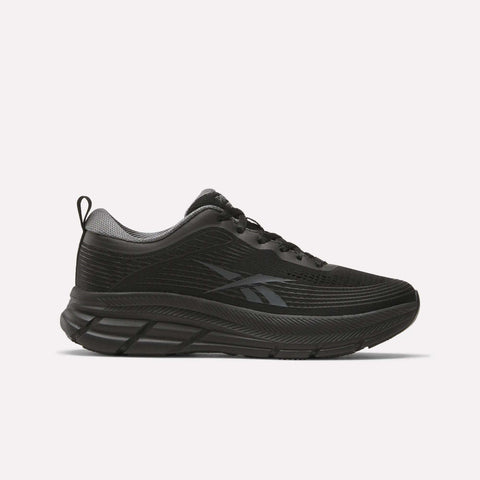 The Women's Road Strider Running Shoes by Reebok feature a black mesh upper, thick textured sole, black laces, subtle branding on the side, and a gray heel accent—ideal lightweight runners for fans of Reebok.