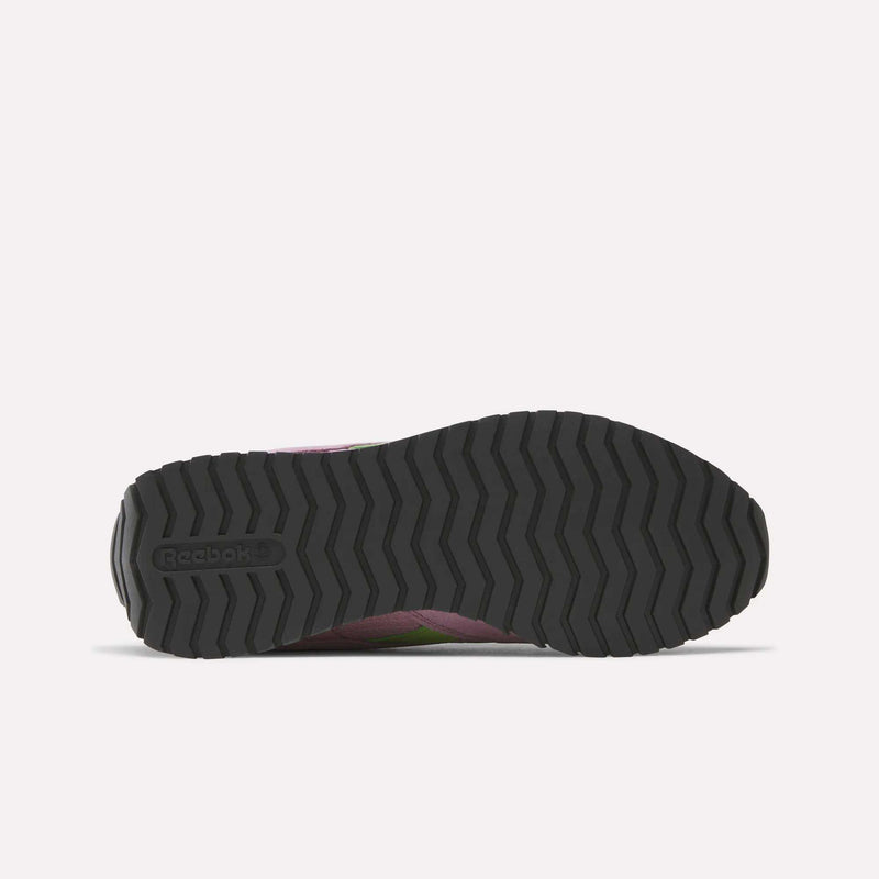 The image shows the black, zigzag-patterned sole of a Reebok Women's Classic AZ Shoe, viewed from the bottom. The embossed Reebok logo appears on the left side of this retro running shoe’s sole.