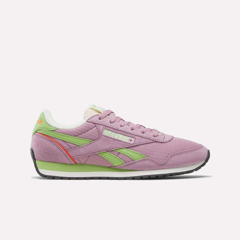 The Women's Classic AZ Shoes by Reebok are shown in side profile in pink with green and orange accents, white laces, and a black sole on a plain white background—a stylish choice for retro running shoe fans.