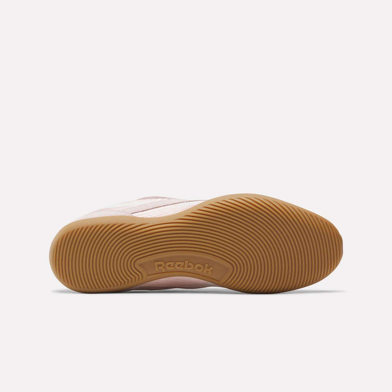 The Women's Ultra Lo Shoes by Reebok feature a tan rubber sole with textured circular patterns and an embossed logo, while the light pink upper brings sport-inspired style that makes this sneaker a standout choice.