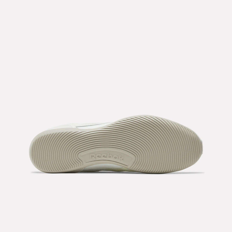 The image shows the bottom view of the Reebok Women's Ultra Lo Shoes in white, featuring a textured rubber sole with curved, wavy grip patterns and the Reebok logo embossed near the center, reflecting their streamlined, low-profile design.