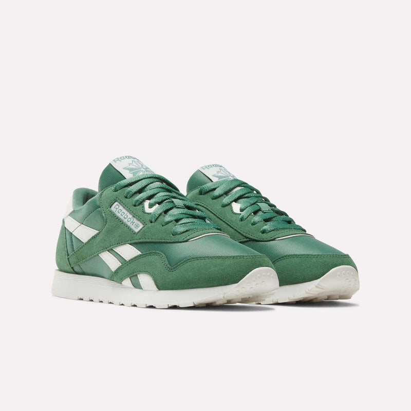 The Women's Classic Nylon Shoes by Reebok, featuring a green nylon and suede upper with white accents and soles, are displayed on a plain light background.