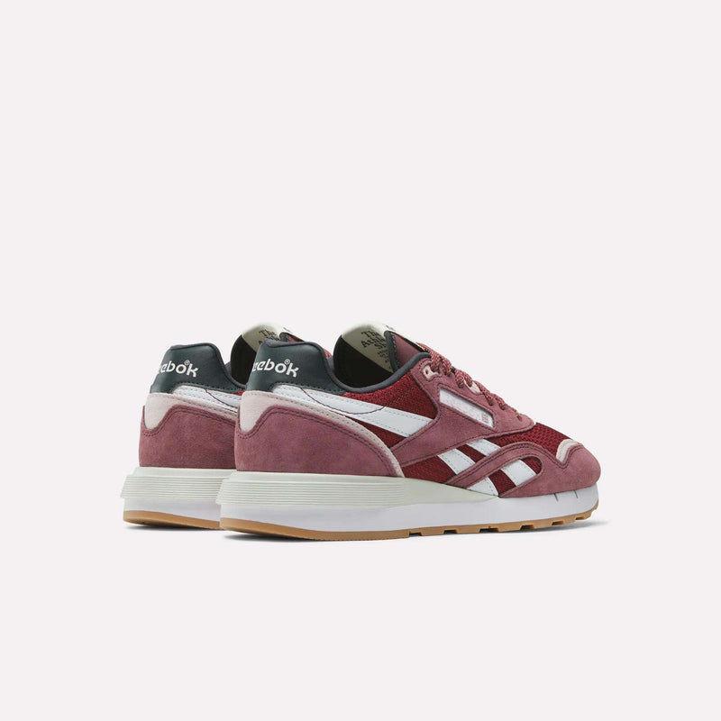 The Reebok Women's Classic Nylon 89 Shoes feature maroon uppers, white side stripes and midsoles, gum outsoles, black heel tabs, and suede accents for a retro look, showcased on a plain white background.