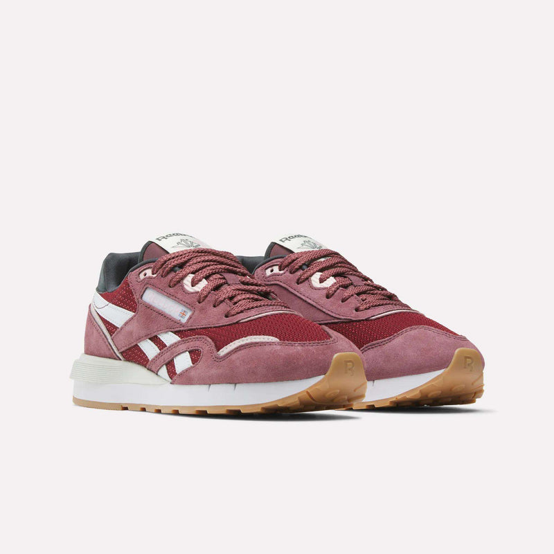 The Women's Classic Nylon 89 Shoes by Reebok are retro maroon sneakers with white accents, suede and mesh uppers, gray heel lining, and tan rubber soles, displayed on a plain white background.