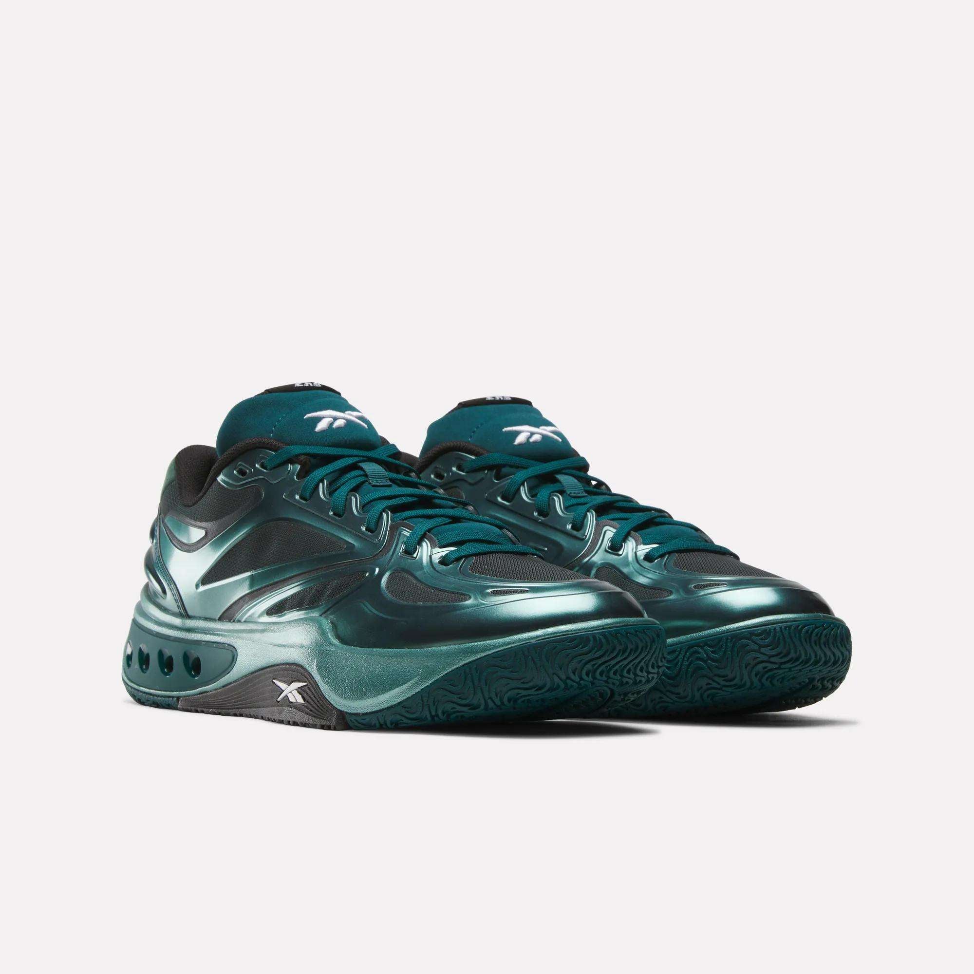 A pair of Reebok Engine A Basketball Shoes in shiny dark green with black accents, low-cut design, and textured ERS soles, displayed on a plain light background.