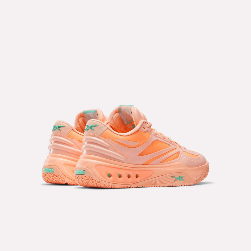 A pair of Reebok Engine A Basketball Shoes in peach with teal accents, featuring a chunky SuperFloat foam sole and modern design, displayed against a plain white background.