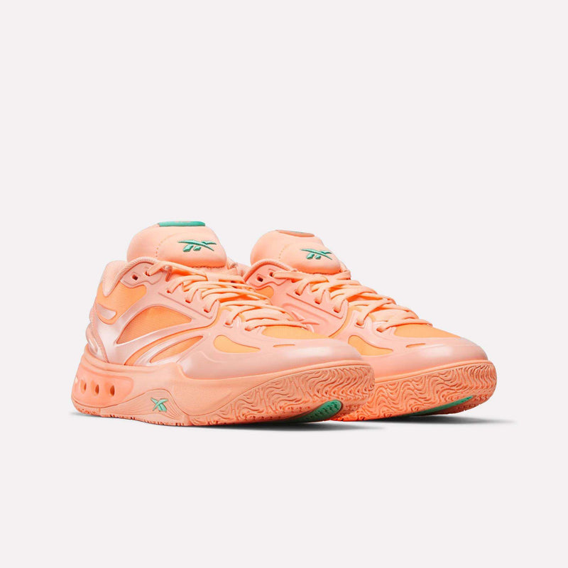 A pair of Reebok Engine A Basketball Shoes in vibrant orange with wavy designs, green accents on the tongue and sole, and a chunky ERS tech sole for superior energy return, displayed against a plain white background.
