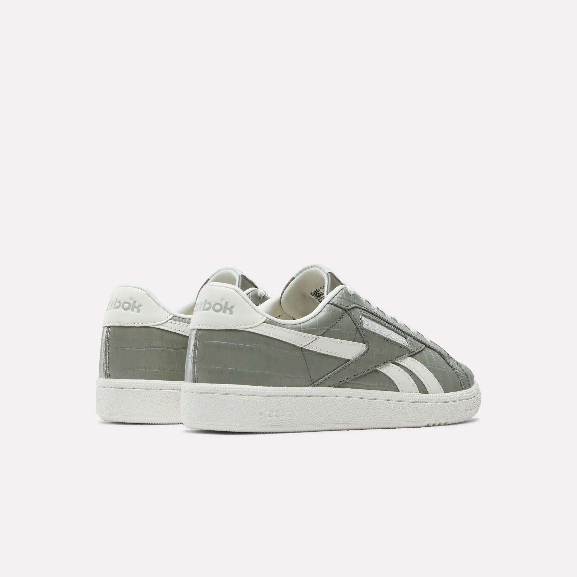 A pair of Reebok Women's Club C Grounds UK Shoes in gray and white premium leather, featuring the brand logo on the heel and side, displayed on a white background with one shoe slightly behind the other.