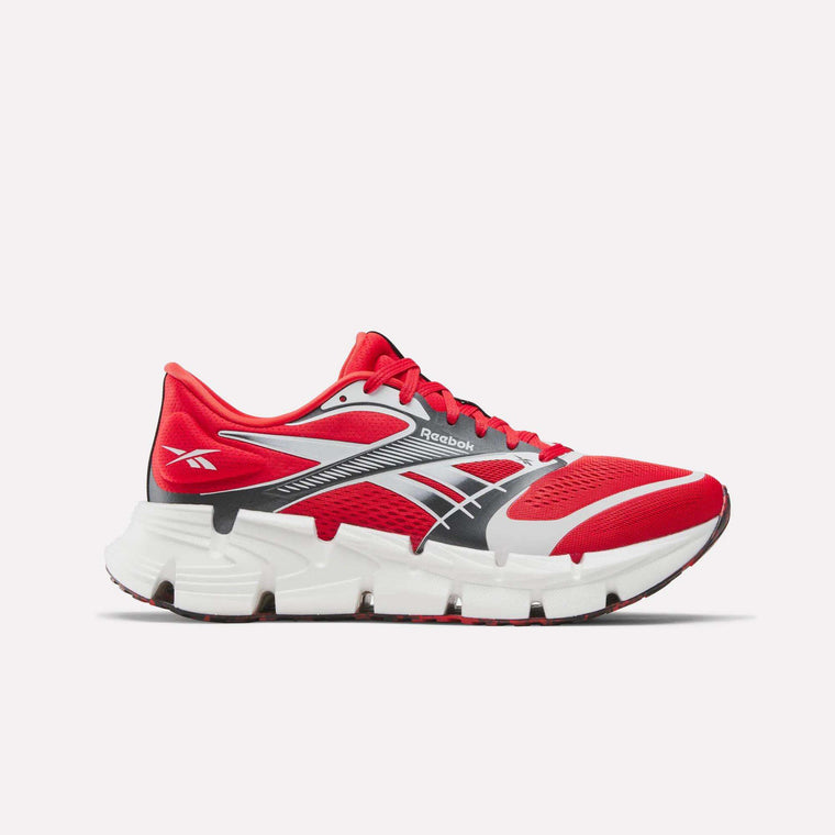 The Reebok FloatZig 2 Running Shoes feature a red design with white and black accents, a supportive upper, lace-up closure, and a chunky segmented sole with Superfloat+ cushioning for enhanced comfort and support.