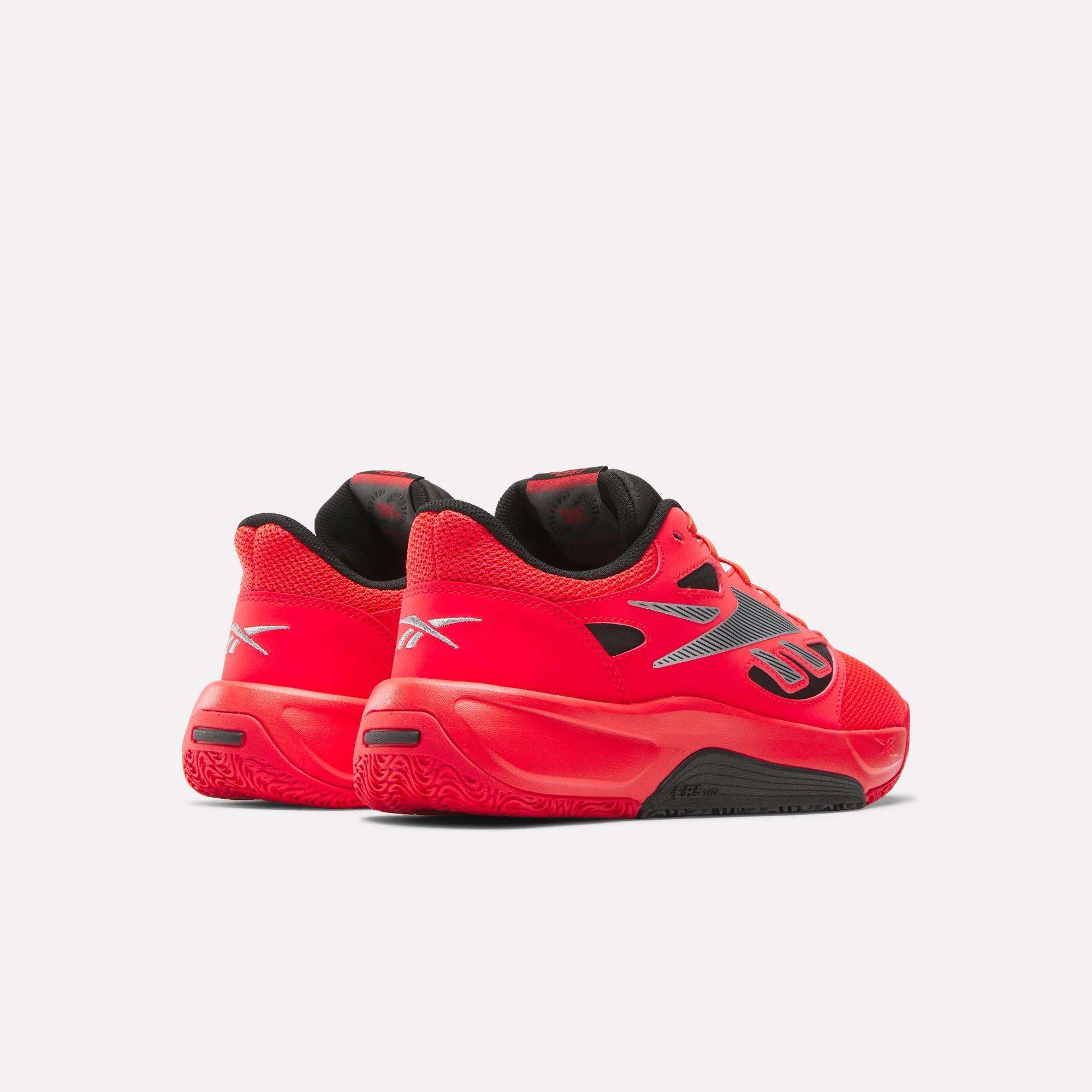 A pair of Reebok Engine LT Shoes in bright red with black and silver accents, displayed from the back and side on a plain white background.