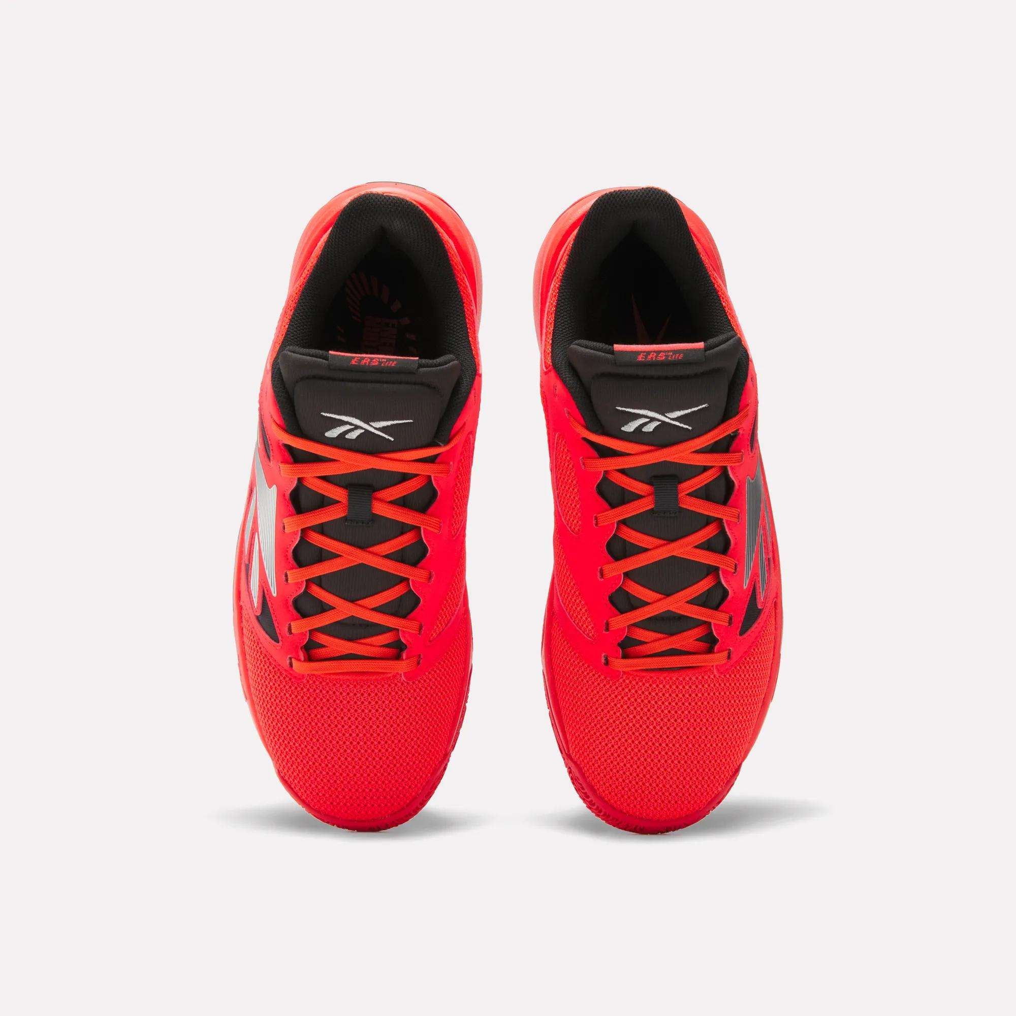 Top view of a pair of Reebok Engine LT Shoes in bright red with black interiors, black and red tongues, and black side detailing, displayed on a plain white background.