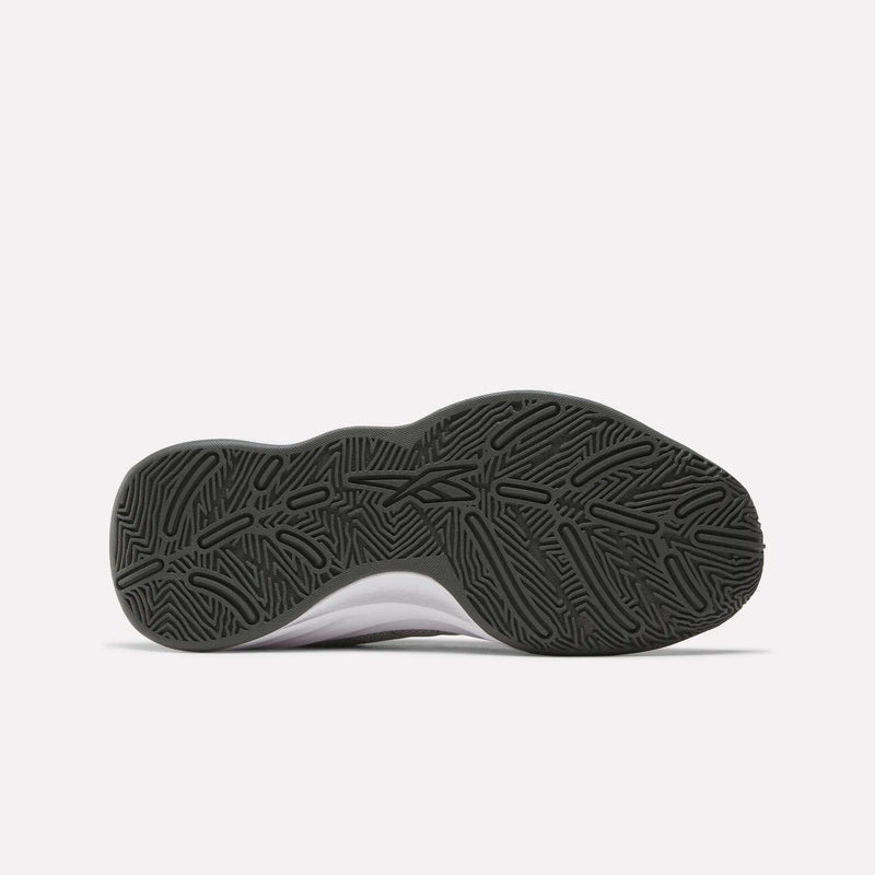 The image shows the bottom view of Reebok Press Basketball Shoes, featuring a black, textured rubber sole with a wavy, geometric tread and a partially visible white upper that highlights its basketball-inspired design.