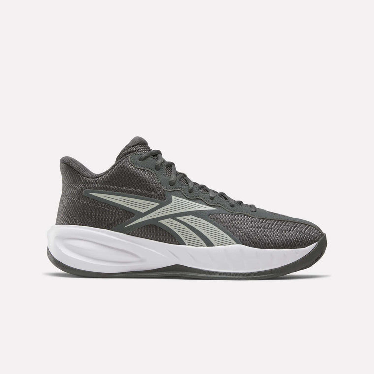 The Reebok Press Basketball Shoes are dark gray athletic sneakers with a white sole and a light gray side logo, featuring basketball heritage and EVA cushioning, displayed on a plain light background.