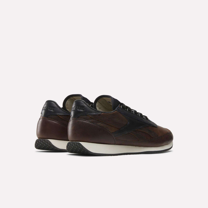 The Reebok Camargue x C.F. Stead Shoes are brown and black full-grain leather sneakers with white soles, shown from the back and side against a plain light background.